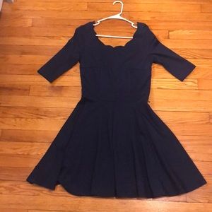 Side zip navy dress with scalloped neckline.